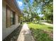 Well-manicured front yard with mature trees and a concrete walkway at 1053 Cavern Dr, Apopka, FL 32712