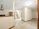 Open hallway featuring tile floors, neutral walls, and wood trim at 1053 Cavern Dr, Apopka, FL 32712
