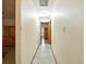 Hallway with tile flooring and natural wood trim connecting different areas of the house at 1053 Cavern Dr, Apopka, FL 32712