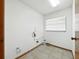 Bright laundry room with tile floors, utility connections, and a window providing natural light at 1053 Cavern Dr, Apopka, FL 32712