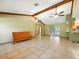 Large living room with tile flooring, ceiling fans, wood accents, and sliding glass doors to the patio at 1053 Cavern Dr, Apopka, FL 32712