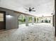Spacious covered patio featuring multiple archways and ceiling fans overlooking the backyard at 1053 Cavern Dr, Apopka, FL 32712
