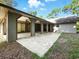 Covered patio with concrete floor and multiple arched openings for outdoor enjoyment at 1053 Cavern Dr, Apopka, FL 32712