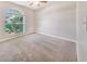 Bright bedroom with carpeted flooring, large window, and neutral paint, creating a cozy retreat at 1055 Bluegrass Dr, Groveland, FL 34736