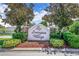 Landscaped entrance to Lexington Village featuring a decorative community sign at 1055 Bluegrass Dr, Groveland, FL 34736