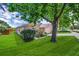 Well-manicured lawn surrounding the house, mature tree in front of home at 1055 Bluegrass Dr, Groveland, FL 34736