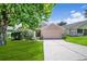 Charming single-story home featuring a well-maintained lawn and a two-car garage at 1055 Bluegrass Dr, Groveland, FL 34736