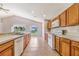Spacious kitchen with tile flooring, wood cabinetry and stainless-steel appliances at 1055 Bluegrass Dr, Groveland, FL 34736