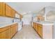 Bright kitchen with ample countertop space, wood cabinets, and modern appliances at 1055 Bluegrass Dr, Groveland, FL 34736
