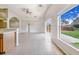 Large living room area with tile flooring and sliding glass doors to the backyard at 1055 Bluegrass Dr, Groveland, FL 34736