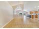 Bright and airy open-concept living space with tile flooring and archway architectural details at 1055 Bluegrass Dr, Groveland, FL 34736