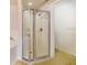 This bathroom features a glass-enclosed shower with a silver finish and neutral tile at 1055 Bluegrass Dr, Groveland, FL 34736