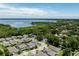 Expansive aerial view of a residential neighborhood near Lake Dora, surrounded by lush trees and water views at 1131 Dora Parc Ln, Mount Dora, FL 32757