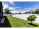 Fully fenced backyard with well-maintained grass, perfect for outdoor activities and relaxation under the sunny sky at 1131 Dora Parc Ln, Mount Dora, FL 32757
