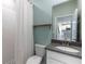 Bathroom featuring a walk-in shower, a vanity with a gray countertop, and a toilet at 1131 Dora Parc Ln, Mount Dora, FL 32757