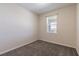 Neutral bedroom featuring wall-to-wall carpeting and one large window at 1131 Dora Parc Ln, Mount Dora, FL 32757
