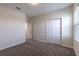 Bedroom featuring plush carpet, a window and a closet with bi-fold doors at 1131 Dora Parc Ln, Mount Dora, FL 32757
