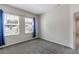 Bright bedroom with plush carpet and two large windows offering neighborhood views at 1131 Dora Parc Ln, Mount Dora, FL 32757