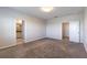 Spacious bedroom with neutral paint, plush carpet, and doorways leading to the bathroom and closet at 1131 Dora Parc Ln, Mount Dora, FL 32757
