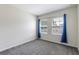 Cozy bedroom with plush carpet, two windows with blue curtains allowing ample natural light at 1131 Dora Parc Ln, Mount Dora, FL 32757
