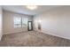 Primary bedroom featuring carpeting, three windows and en-suite bathroom at 1131 Dora Parc Ln, Mount Dora, FL 32757