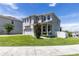 Side view of a two-story home featuring a welcoming porch, tidy lawn, and a two-car garage at 1131 Dora Parc Ln, Mount Dora, FL 32757