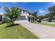 Charming two-story home with a paved driveway and lush landscaping enhancing the curb appeal at 1131 Dora Parc Ln, Mount Dora, FL 32757