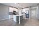 Modern kitchen with white cabinets, an island with pendant lighting, and stainless steel appliances at 1131 Dora Parc Ln, Mount Dora, FL 32757