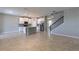 Open-concept living area with tile flooring, kitchen island, and staircase for easy access to upper levels at 1131 Dora Parc Ln, Mount Dora, FL 32757