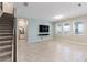 Large, open living room with tile floor and a wall-mounted television at 1131 Dora Parc Ln, Mount Dora, FL 32757