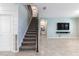 Open-concept living space featuring stairs, a TV area, and tile flooring at 1131 Dora Parc Ln, Mount Dora, FL 32757