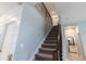 Carpeted staircase featuring neutral walls and an open design at 1131 Dora Parc Ln, Mount Dora, FL 32757