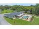 Expansive aerial view of the property showcasing the pool, outdoor living space, and lush green surroundings at 14227 County Road 455, Clermont, FL 34711