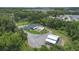 Aerial view showcasing a sprawling property with a pool, guest house and extensive landscaping at 14227 County Road 455, Clermont, FL 34711