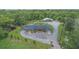 Stunning aerial view of a large estate with a pool, guesthouse, and lush greenery at 14227 County Road 455, Clermont, FL 34711