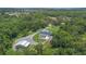 Lush property with home, pool and barn photographed from an aerial view at 14227 County Road 455, Clermont, FL 34711