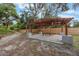 Backyard featuring a covered outdoor seating area, ideal for relaxation and enjoying the natural surroundings at 14227 County Road 455, Clermont, FL 34711