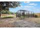 Backyard space with an enclosed gardening area and trampoline, offering a private and playful outdoor space at 14227 County Road 455, Clermont, FL 34711