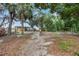 Large backyard with recreational areas, including a covered patio and fire pit, perfect for outdoor activities at 14227 County Road 455, Clermont, FL 34711
