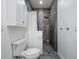 Contemporary bathroom with dark shower tile and white vanity at 14227 County Road 455, Clermont, FL 34711