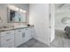 Bright bathroom with granite countertops, white cabinets, and modern fixtures at 14227 County Road 455, Clermont, FL 34711
