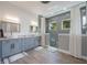 Stylish bathroom featuring double sinks, a tiled shower, and modern fixtures at 14227 County Road 455, Clermont, FL 34711