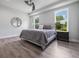 Comfortable bedroom with wood floors, a ceiling fan, and large windows at 14227 County Road 455, Clermont, FL 34711