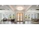 Grand entryway featuring elegant chandelier lighting, wood floors, and ample natural light from surrounding windows at 14227 County Road 455, Clermont, FL 34711