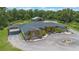 Beautiful home with a circular driveway, porte cochere, stone accents and manicured landscaping at 14227 County Road 455, Clermont, FL 34711