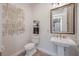 Stylish half bathroom featuring modern fixtures, decorative wall art, and neutral colors at 14227 County Road 455, Clermont, FL 34711