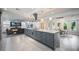 Open-concept kitchen featuring stainless steel appliances, a large island, and a view into the living space at 14227 County Road 455, Clermont, FL 34711