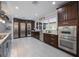 Modern kitchen with stainless steel appliances, dark wood cabinetry, and a view of the backyard at 14227 County Road 455, Clermont, FL 34711