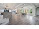 Bright and airy open-concept living space, with a kitchen island, dining area, and cozy living area with a fireplace at 14227 County Road 455, Clermont, FL 34711