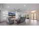Modern living room with a fireplace, large screen television, and plenty of seating at 14227 County Road 455, Clermont, FL 34711